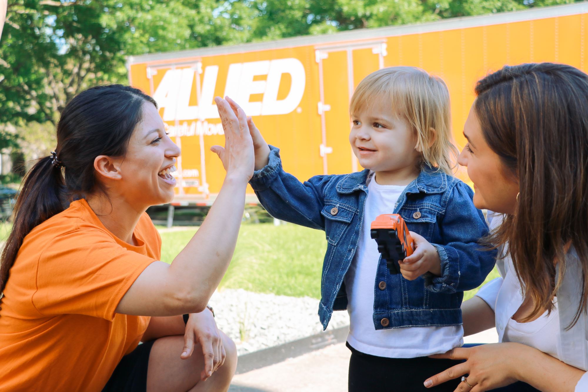 Child high-fiving Allied mover